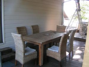 a wooden table and chairs on a porch at Wellness und Wander Oase Burgwald 