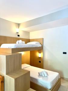 Ένα ή περισσότερα κρεβάτια σε δωμάτιο στο Hostdomus - Mughetto Apartment