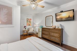 a bedroom with a bed and a dresser and a mirror at THE WHITEHEAD ROOM at Inn on Fleming Key West! in Key West +23 photos