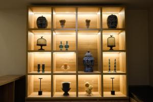 a display case with vases and other items on display at Midtown Boutique Hotel in Buenos Aires