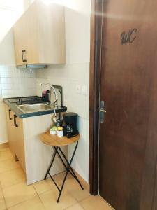 a small kitchen with a sink and a door at Blue Hotel Apartments in Ierissos +78 photos