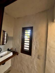 a bathroom with a sink and a window at Casa Socó Guriu in Guriú +45 photos