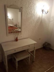 a dressing table in a room with a mirror at Archipelagos in Naxos Chora