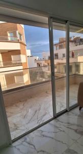 an empty room with sliding glass doors looking out onto a patio at Touristique in Kelibia +2 photos