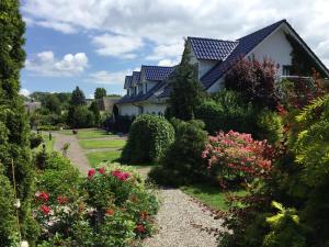 una casa con un jardín de flores y arbustos en Appartementanlage Zur Seemöwe en Insel Poel