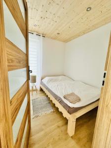 a small bedroom with a bed and a window at Ostoja Drawno in Drawno +61 photos