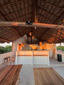 a pavilion with a table and benches in a room at Casa Socó Guriu in Guriú