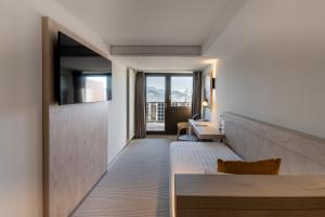 Ένα ή περισσότερα κρεβάτια σε δωμάτιο στο Victoria Hotel & Residence