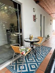 a patio with a table and chairs on a patio at Ocean Lovers Taganga - PADI Dive Center & Hostel in Taganga