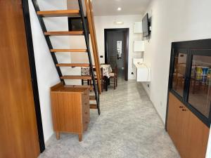 a room with a staircase and a dining room at Magenta49 in Bernalda