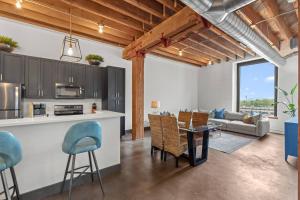 a kitchen and living room with a table and chairs at Brick & Bed, Riverfront Lofts, P 4J in Saint Louis