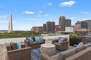 a rooftop patio with furniture and a view of a city at Brick & Bed, Riverfront Lofts, P 4J in Saint Louis