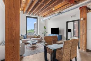 a living room with a table and a couch at Brick & Bed, Riverfront Lofts, P 4J in Saint Louis