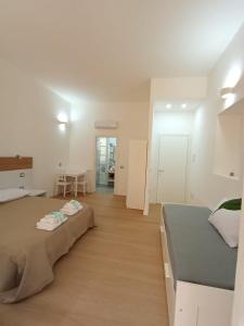 a bedroom with a bed and a dining room at WHITE MOON CAGLIARI via Dettori 5 Centro in Cagliari