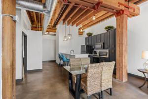 a kitchen and dining room with a table and chairs at Brick & Bed, Riverfront Lofts, P 4J in Saint Louis +22 photos