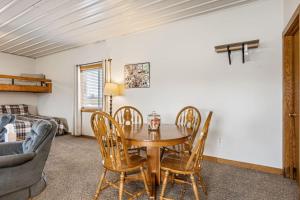 a living room with a wooden table and chairs at Peaceful Riverfront Cabin Sleeps 4 Decatur Nebraska in Onawa