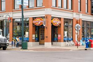 a building with dominoes signs on the side of a street at The Roost 16 on Front 2BR Private Hot Tub Patio in Traverse City