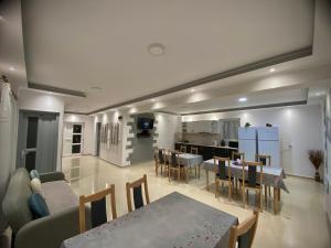a living room with a couch and a table and a kitchen at Casa Alberto in Sovata
