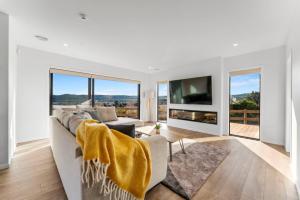a living room with a couch and a tv at Kinloch Lookout in Kinloch