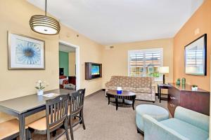 a living room with a couch and a table at Hot Tub & Pool Condo Near to Universal in Orlando