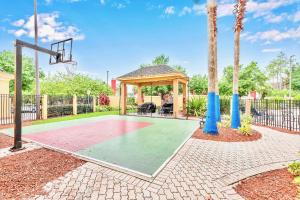 a basketball court with a gazebo and a basketball hoop at Hot Tub & Pool Condo Near to Universal in Orlando
