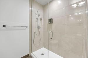 a bathroom with a shower with a glass door at Lakeview Unit - sleeps 11 people near CN Tower Union Rogers Centre and Convention Centre in Toronto +33 photos