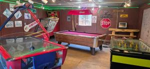 a room with a pool table and a stop sign at King Suite with a Full Kitchen and Balcony at the Cedaredge Lodge in Cedaredge