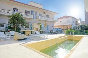 a house with a pool in front of a building at Mpoulakis Apt 46 in Kissamos