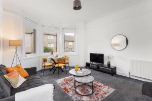 una sala de estar con un sofá y una mesa en Stylish Stay in Inverkeithing., en Fife