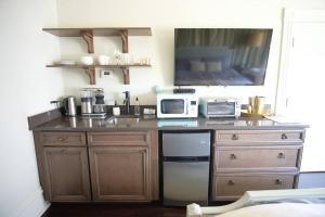 a kitchen with a counter top with a microwave at Mirabelle Suite 4 in the Heart of Savannah's National Historic Landmark District in Savannah