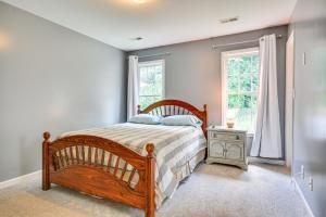 a bedroom with a wooden bed and a window at Less Than 4 Mi to Dtwn Greensboro Renovated Home with Yard! in Greensboro +18 photos