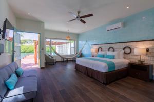 a hotel room with a bed and a couch at Marina Comodoro in Isla Mujeres