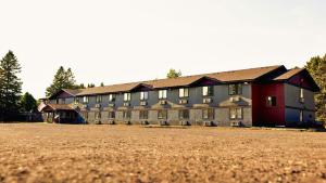 a large building with a field in front of it at Magnuson Hotel Ironwood in Ironwood +23 photos