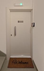 een deur met een welkomstmat ervoor bij Angelique Apartment Corfu Old Town in Corfu