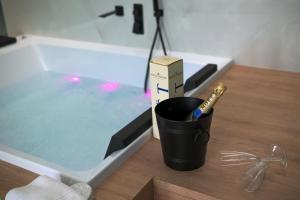 a cup with a pen in it next to a bath tub at Paradiso esotico suite in Polignano a Mare +28 photos