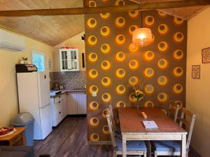 a kitchen with a table and a wall with a polka dot wall at Unique Dutch Retro House "Stará Láska" - Natural Slovakia in Modrý Kameň +15 photos