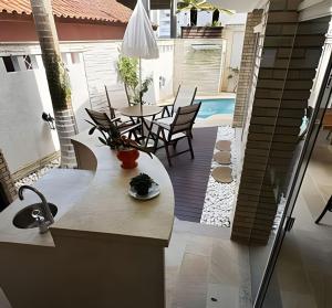 a view of a patio with a table and chairs at CURTA! |135| Casa | Piscina | Prox. Roda Gigante in Cabeçudas +48 photos