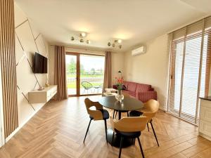a living room with a table and a couch at Apartament River in Pisz