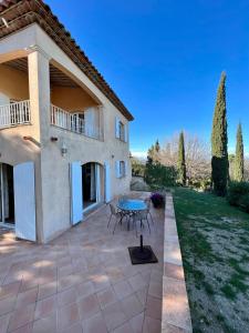 a patio with a table in front of a house at Villa D'arosa - Maison familiale provençale in Ramatuelle