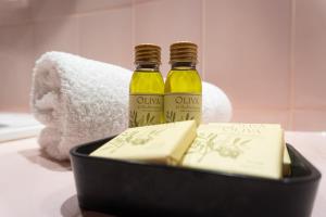 two bottles of oil and cheese in a black container at Villa D'arosa - Maison familiale provençale in Ramatuelle +52 photos