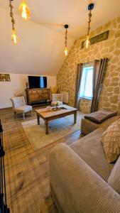 a living room with a couch and a table at Gîte des champs étoilés in Thuboeuf +69 photos