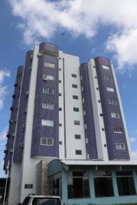 two tall buildings with blue windows on top of them at GOLD MARTAN HOTEL in Belém