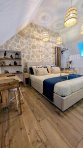 a bedroom with two beds and a stone wall at Gîte des champs étoilés in Thuboeuf +75 photos