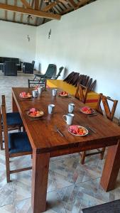 a wooden table with plates of food on it at El Sueño Belga in Golfito