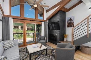 a living room with a fireplace and a ceiling fan at Crestwood 1301 Premier 1 Bedroom plus Loft in Snowmass Village