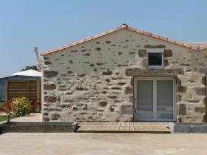 a stone building with a window and a door at La Mariennaye in Beaurepaire +4 photos