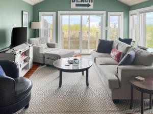 a living room with a couch and a table at 277 Phillips Road Sandwich - Cape Cod in Sagamore Beach