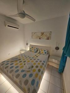 a bedroom with a bed and a ceiling fan at My sweet home in Paphos +28 photos