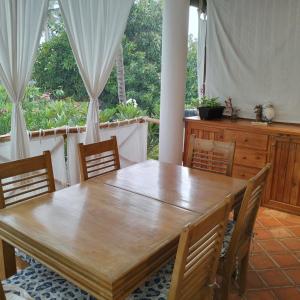 a dining room with a wooden table and chairs at Fiocco di neve in Watamu