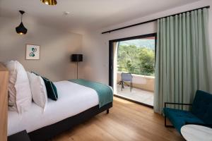 a hotel room with a bed and a balcony at Hôtel Sainte Victoire in Vauvenargues +39 photos